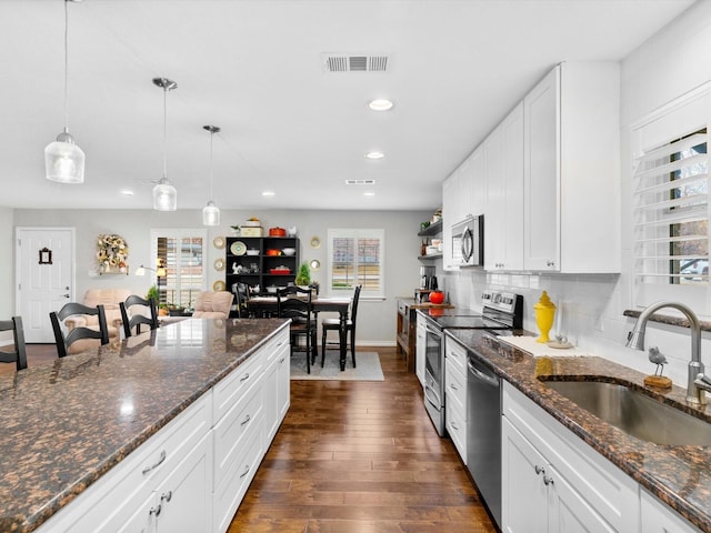 kitchen featuring white cabinets, a healthy amount of sunlight, and sink