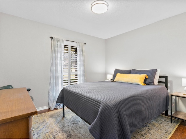 bedroom with dark wood-type flooring