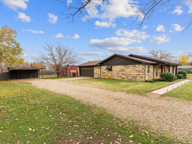 view of property exterior with a carport, a garage, and a yard