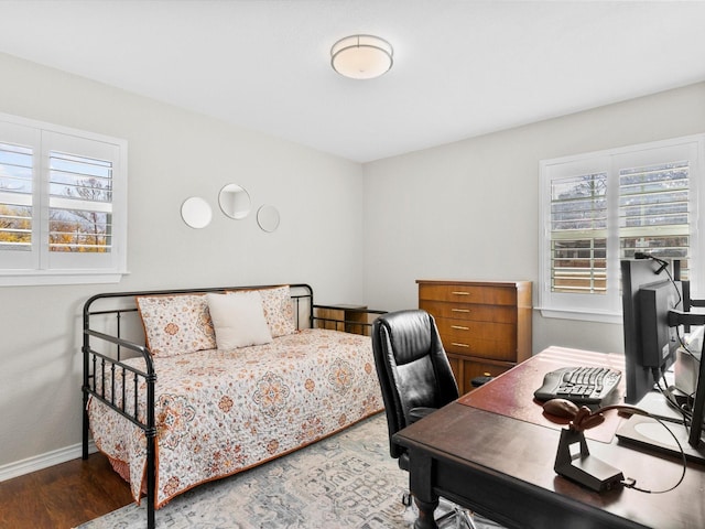 bedroom with hardwood / wood-style flooring