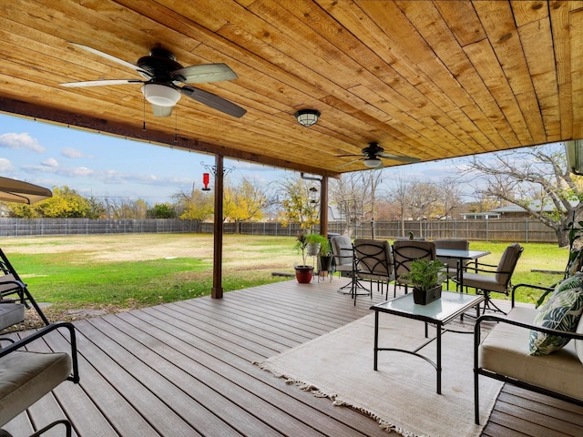 deck featuring ceiling fan and a yard