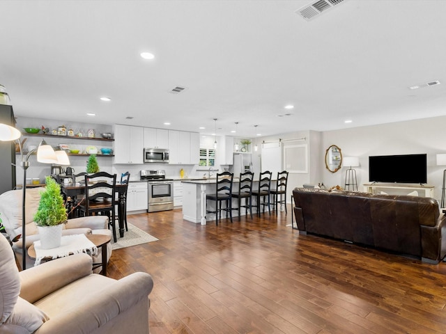 living room with dark hardwood / wood-style flooring