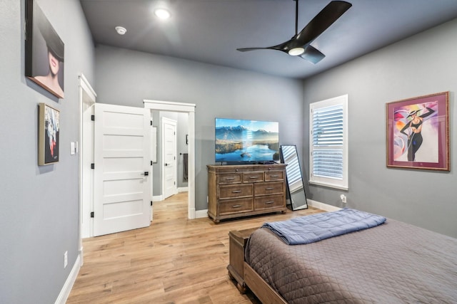 bedroom featuring light wood finished floors, ceiling fan, and baseboards