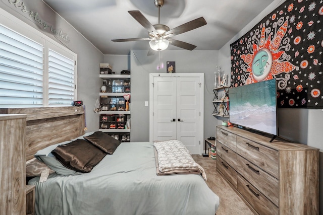 bedroom featuring light carpet and ceiling fan