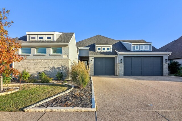 view of front facade with a garage and central AC