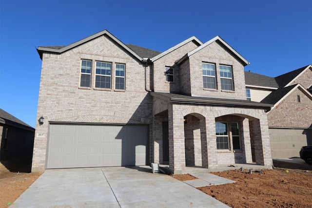 view of front of property with a shingled roof, brick siding, driveway, and an attached garage