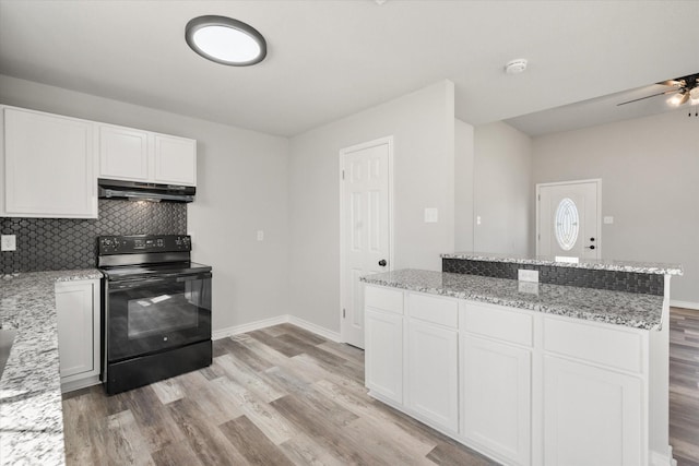 kitchen with white cabinets, decorative backsplash, light hardwood / wood-style floors, and black range with electric stovetop