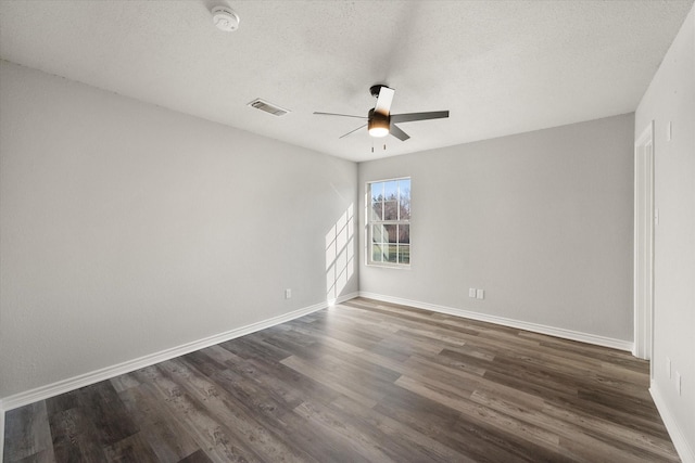 unfurnished room with dark hardwood / wood-style floors, a textured ceiling, and ceiling fan