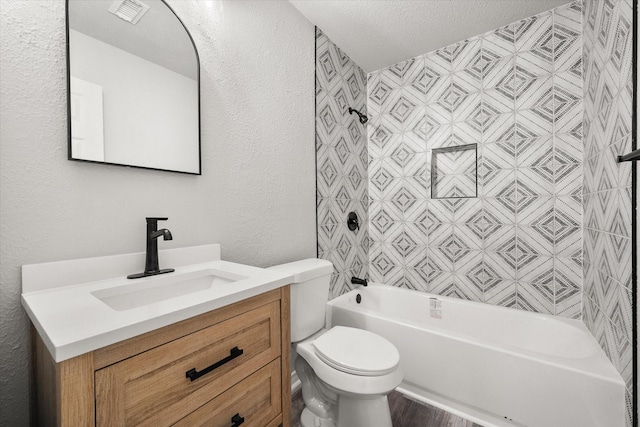 full bathroom featuring shower / bathing tub combination, vanity, a textured ceiling, and toilet