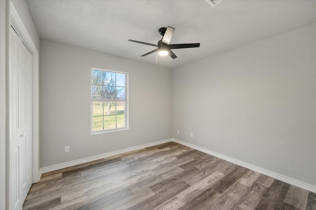 unfurnished bedroom with ceiling fan, a closet, and light hardwood / wood-style flooring