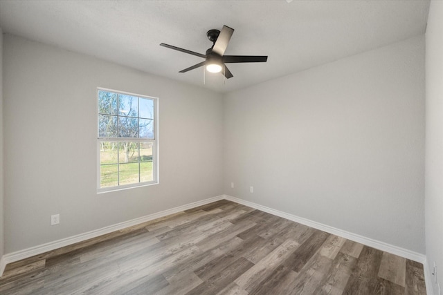 empty room with hardwood / wood-style floors and ceiling fan