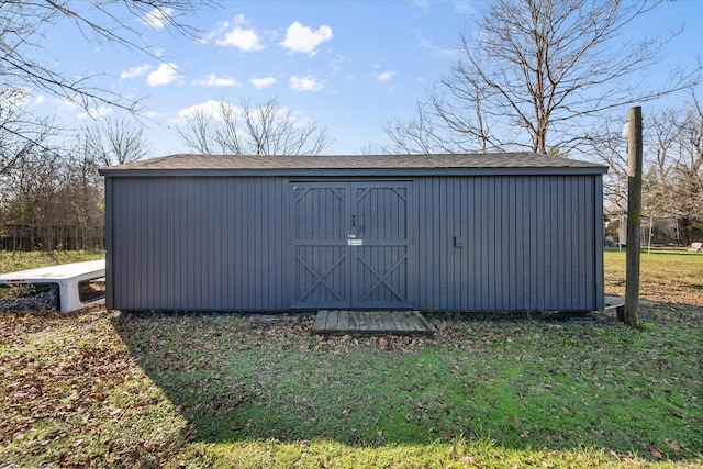 view of outbuilding with a lawn