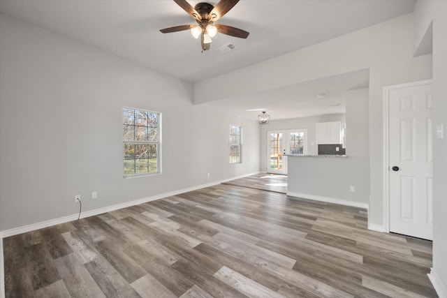 unfurnished living room featuring wood-type flooring and ceiling fan