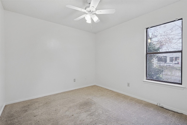 spare room featuring carpet flooring and ceiling fan