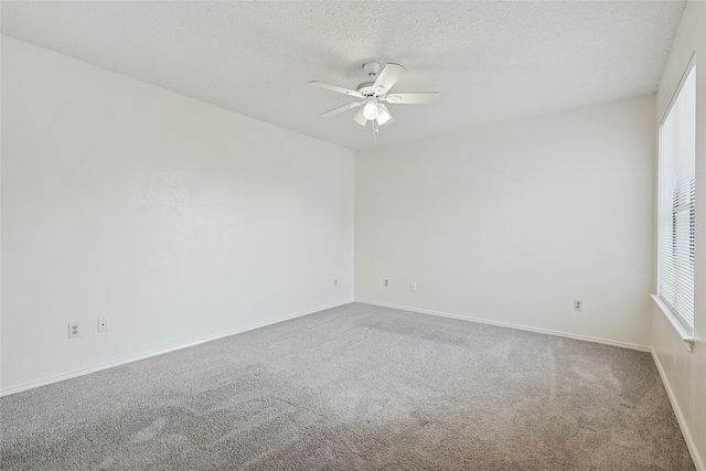 unfurnished room featuring ceiling fan, carpet floors, and a textured ceiling