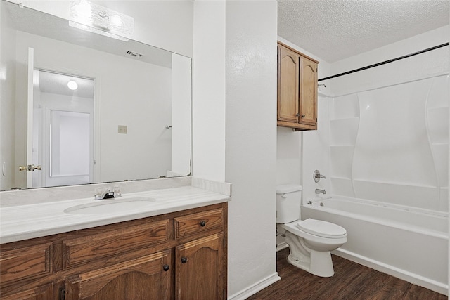 full bathroom with  shower combination, toilet, a textured ceiling, vanity, and hardwood / wood-style flooring