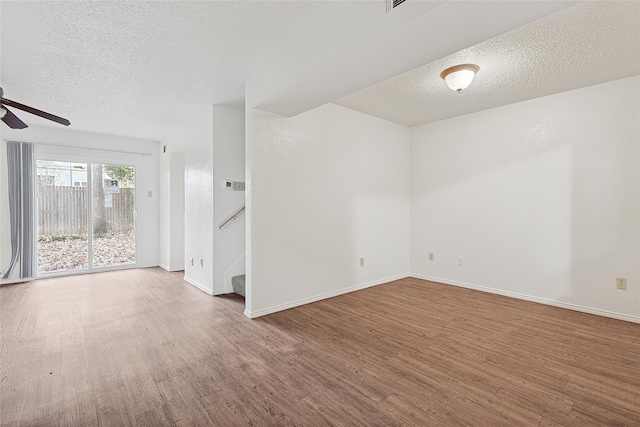 empty room featuring hardwood / wood-style flooring, ceiling fan, and a textured ceiling