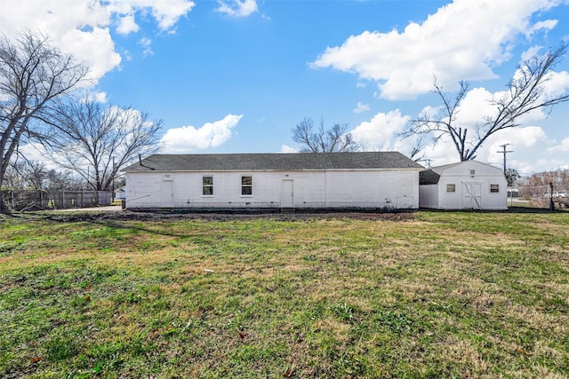 back of house with a lawn