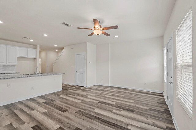 empty room with dark hardwood / wood-style floors, ceiling fan, and a textured ceiling