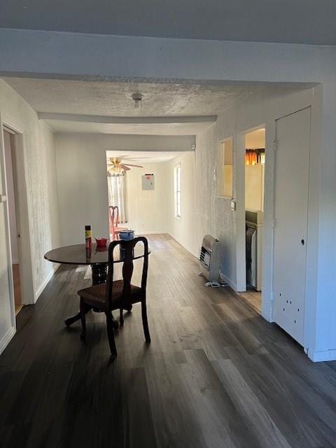 dining area with beamed ceiling, dark hardwood / wood-style flooring, heating unit, and ceiling fan