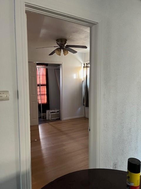 hall with hardwood / wood-style floors