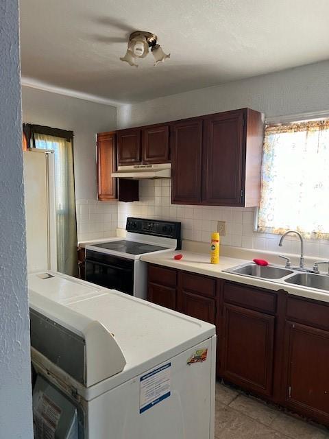 kitchen with white appliances, tasteful backsplash, and sink