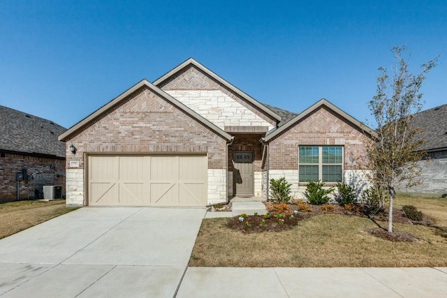 view of front of property with central AC unit, a garage, and a front lawn