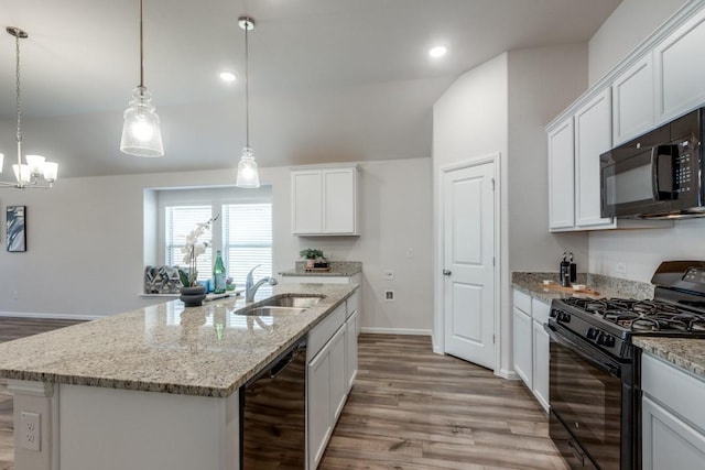 kitchen with white cabinetry, sink, lofted ceiling, a kitchen island with sink, and black appliances