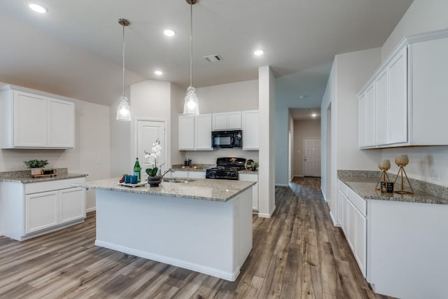 kitchen with white cabinetry, hanging light fixtures, black appliances, and hardwood / wood-style flooring