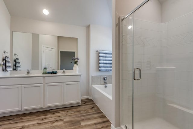 bathroom featuring vanity, hardwood / wood-style flooring, and separate shower and tub