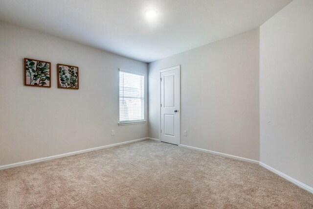 empty room featuring light carpet