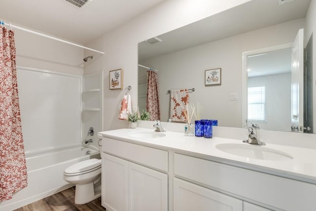 full bathroom with toilet, hardwood / wood-style floors, vanity, and shower / tub combo with curtain