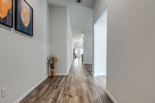 hallway with hardwood / wood-style flooring