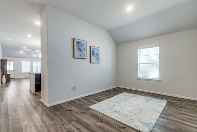 spare room featuring ceiling fan, dark hardwood / wood-style floors, and lofted ceiling