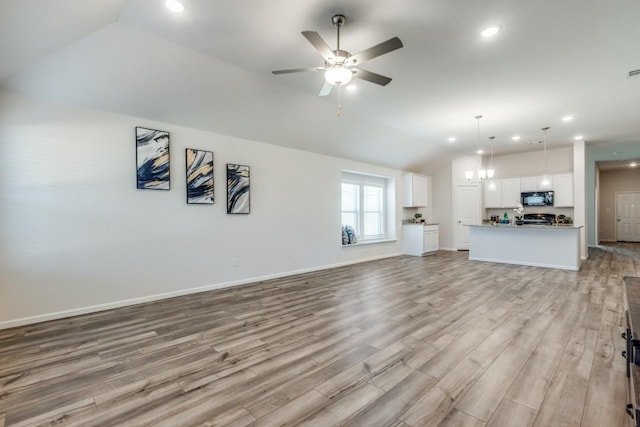 unfurnished living room featuring light hardwood / wood-style floors, ceiling fan, and lofted ceiling