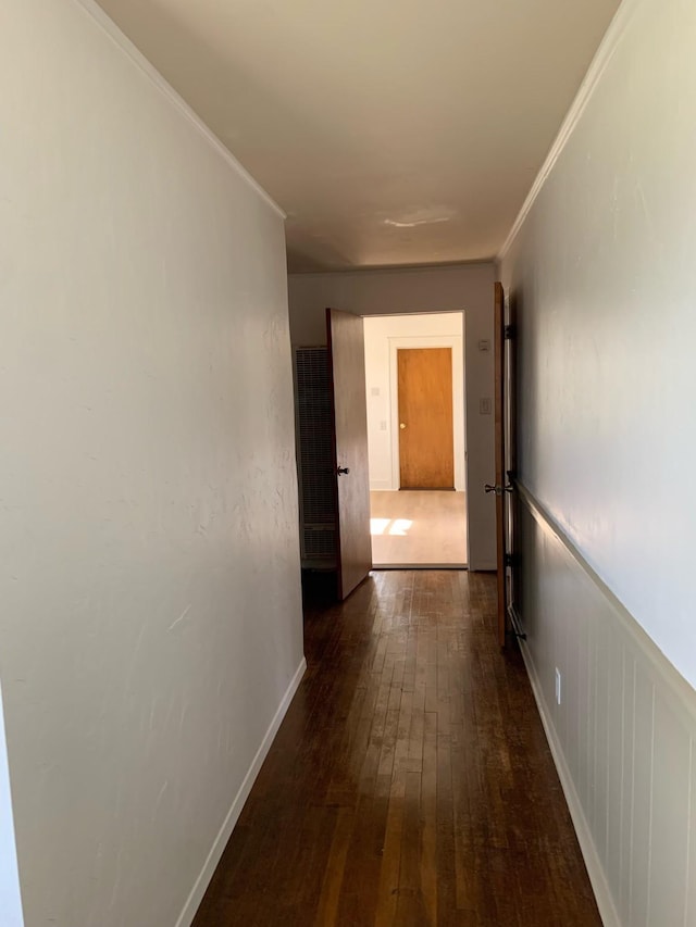 hallway featuring dark hardwood / wood-style flooring and ornamental molding