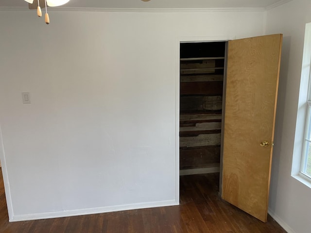 empty room with crown molding, ceiling fan, and dark hardwood / wood-style floors