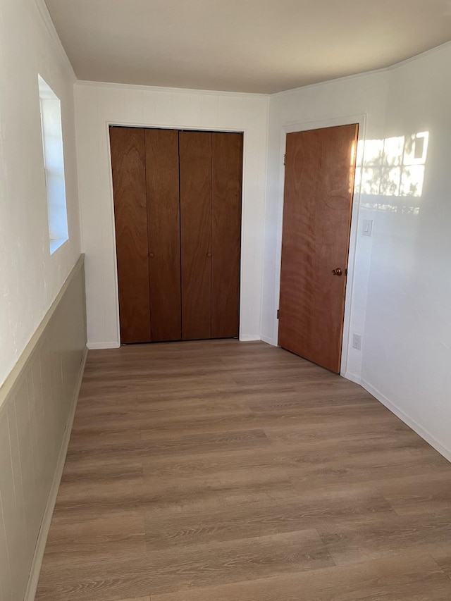 unfurnished bedroom featuring a closet and light wood-type flooring