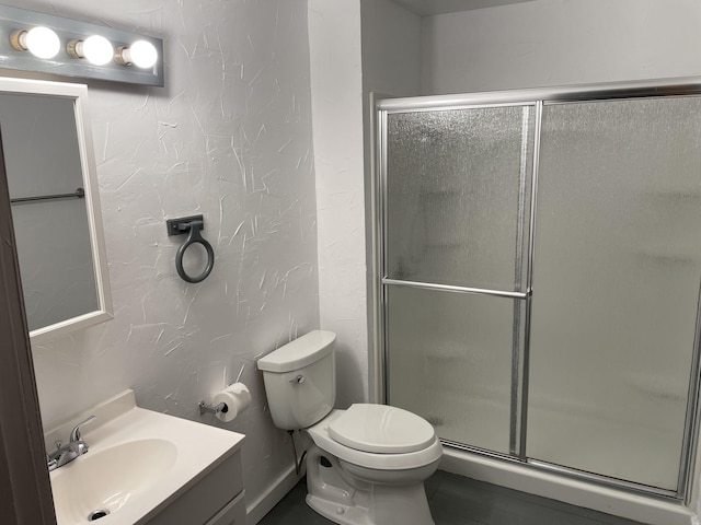 bathroom with vanity, toilet, and walk in shower