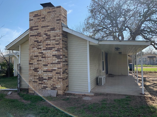 view of side of home with a patio