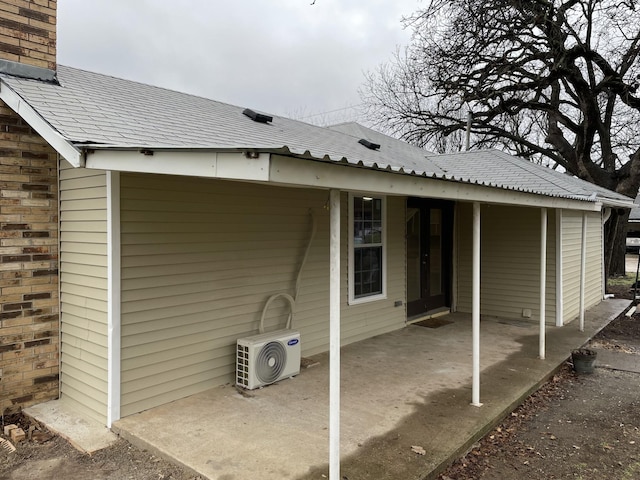 view of property exterior with ac unit and a patio area