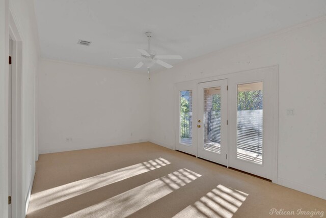 empty room with light colored carpet and ceiling fan