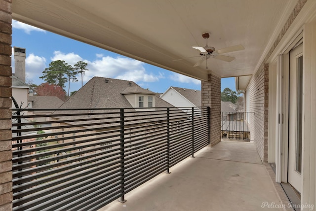 exterior space with ceiling fan and a balcony