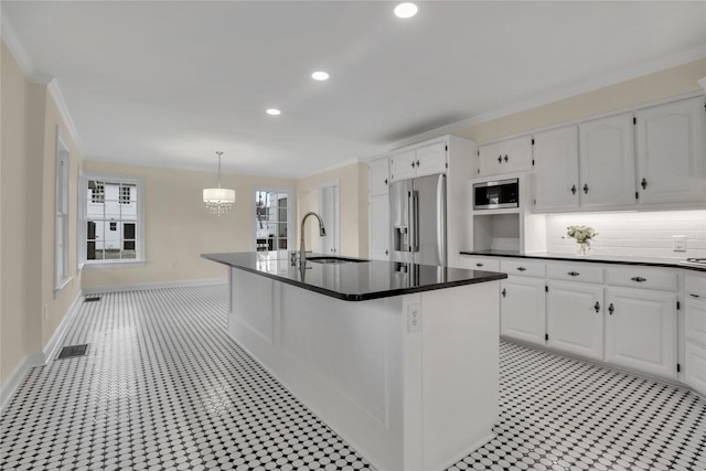 1102 Howell St, Mckinney, TX 75069 - kitchen with stainless steel appliances, white cabinets, dark countertops, a chandelier, and recessed lighting