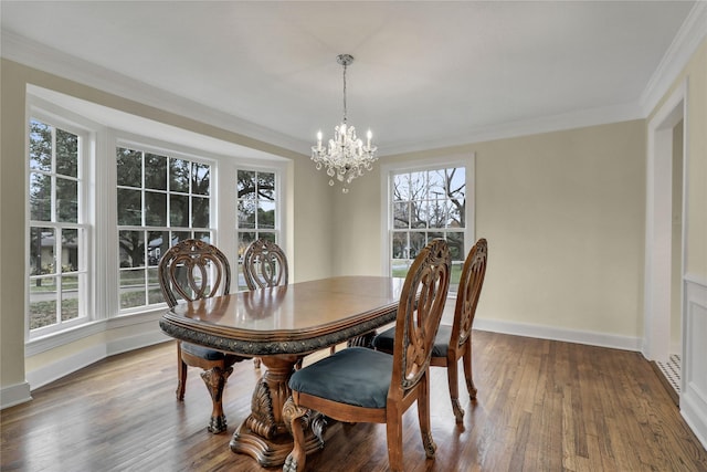 dining room featuring ornamental molding, an inviting chandelier, baseboards, and wood finished floors