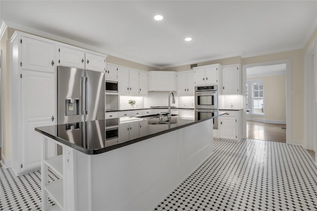 kitchen featuring stainless steel appliances, white cabinets, and a sink