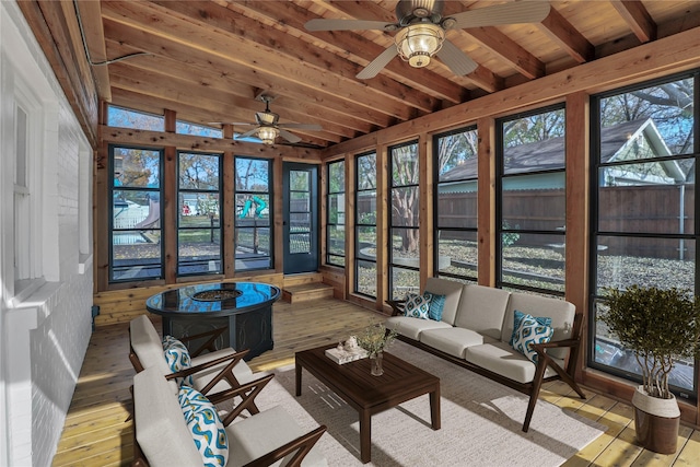 sunroom / solarium featuring wood ceiling, ceiling fan, and beam ceiling