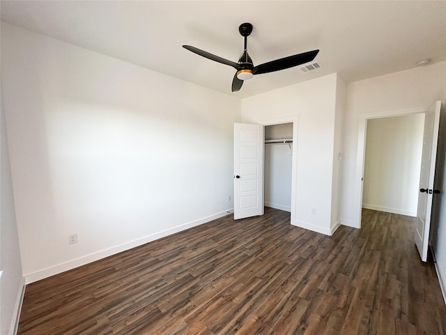 unfurnished bedroom with a closet, ceiling fan, and dark wood-type flooring