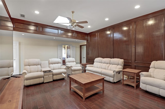 cinema room with ceiling fan and a skylight