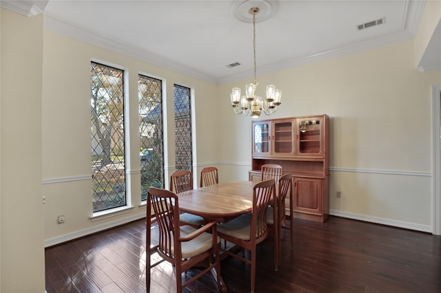 dining room with a notable chandelier, ornamental molding, and dark wood-type flooring